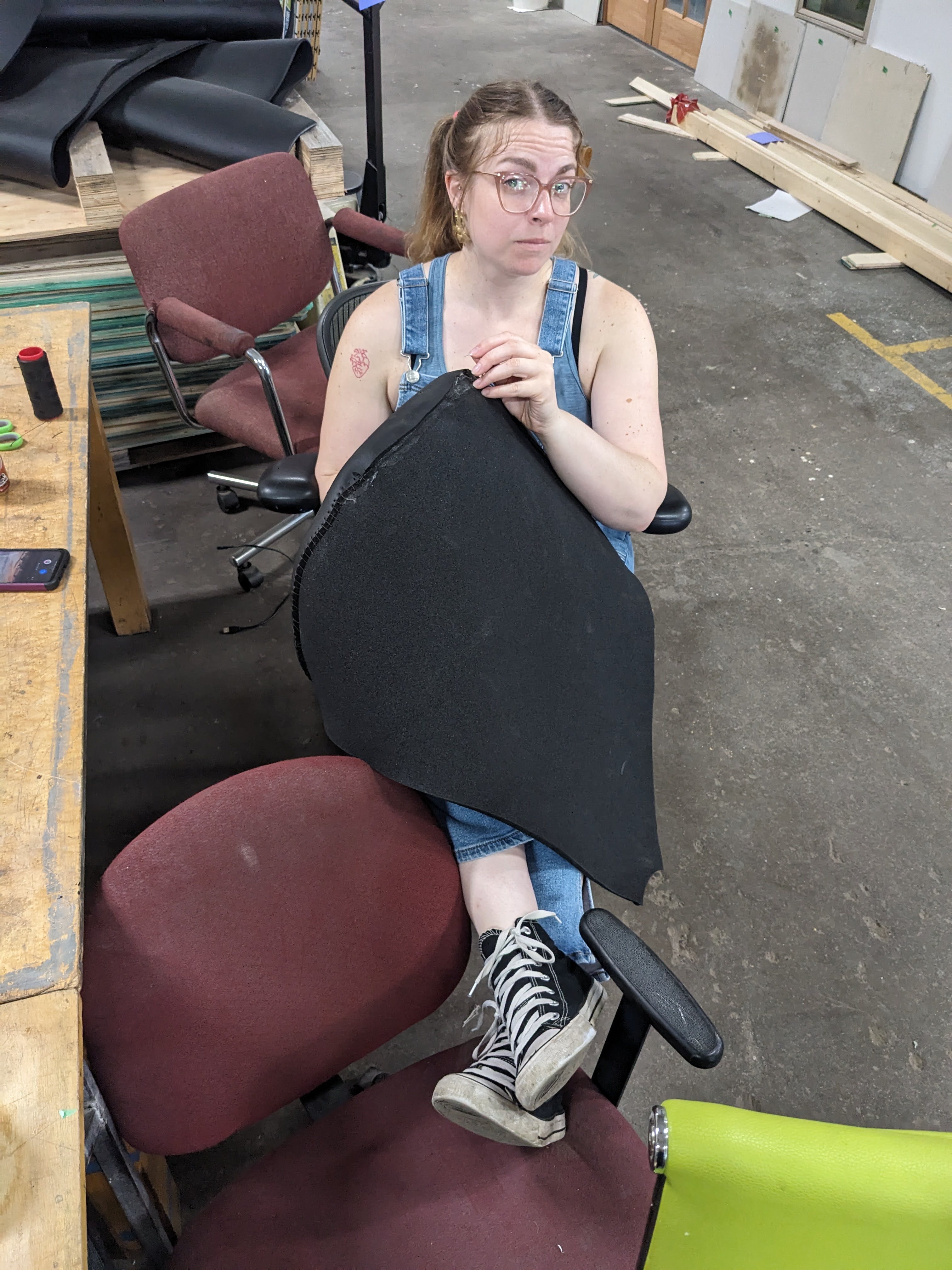 Kara Bradley sews a bicep of the puppet.