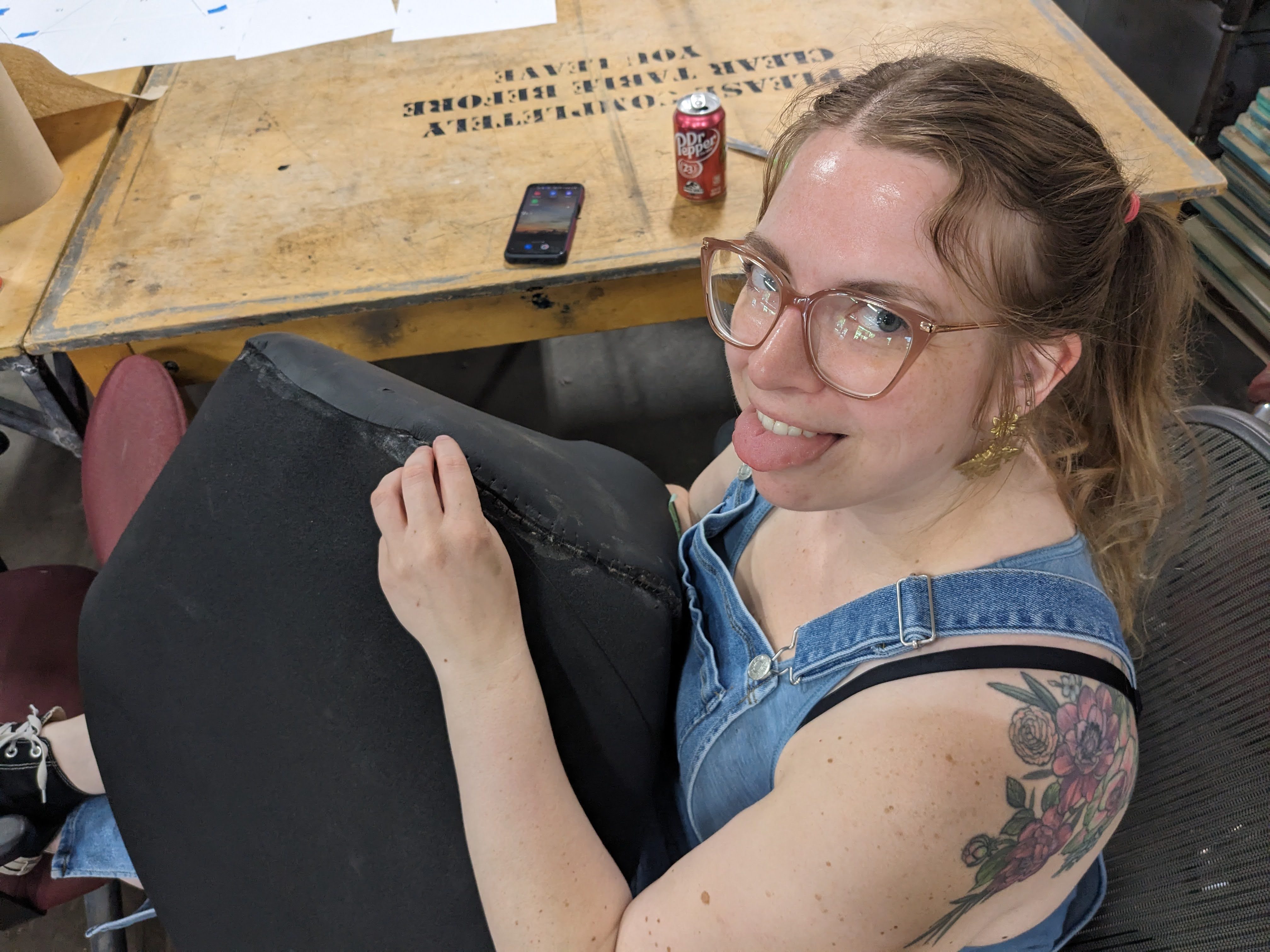 Kara Bradley sews a bicep of the puppet.