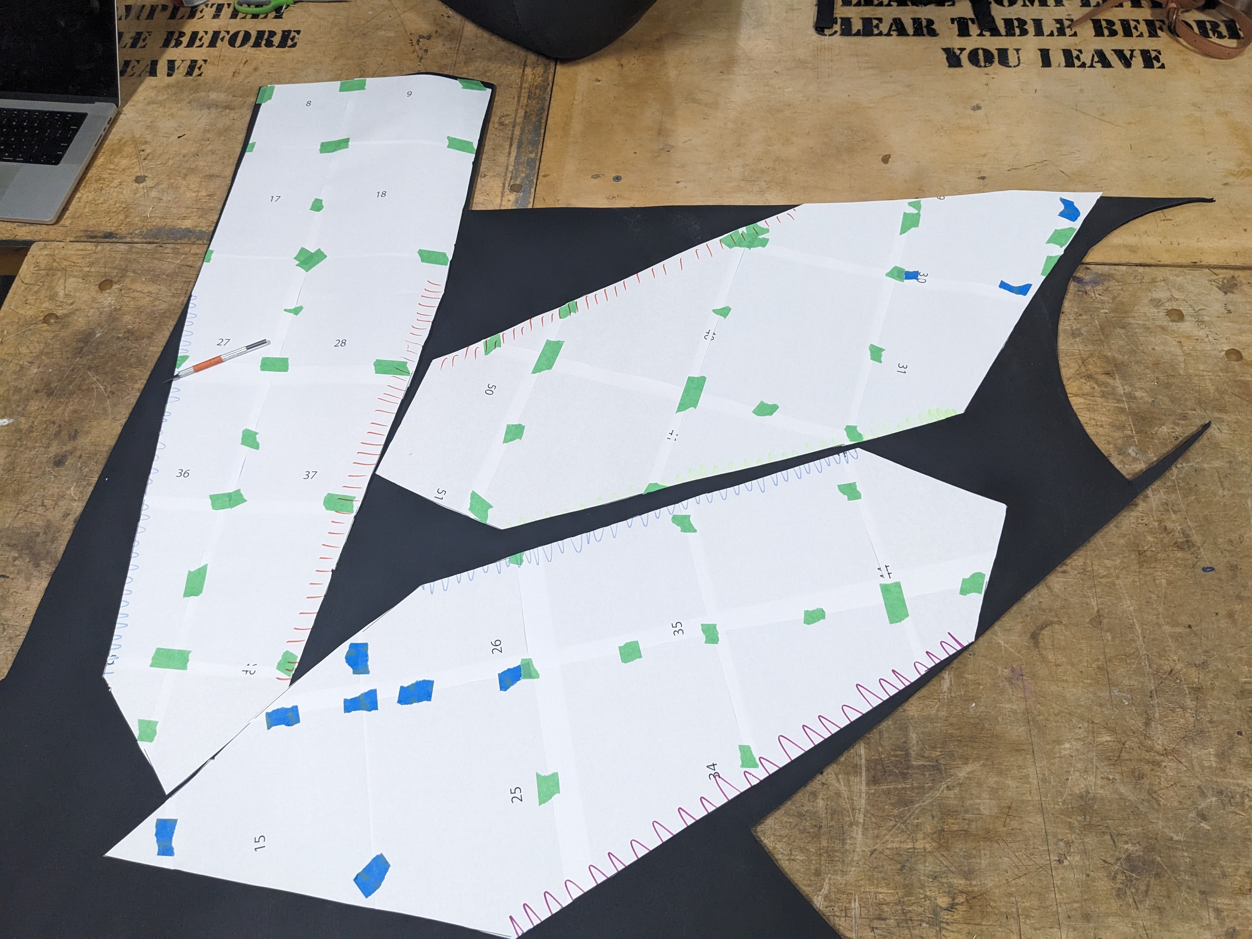 A pattern is laid out over a sheet of gynmasium floor rubber. These are parts of a thigh.