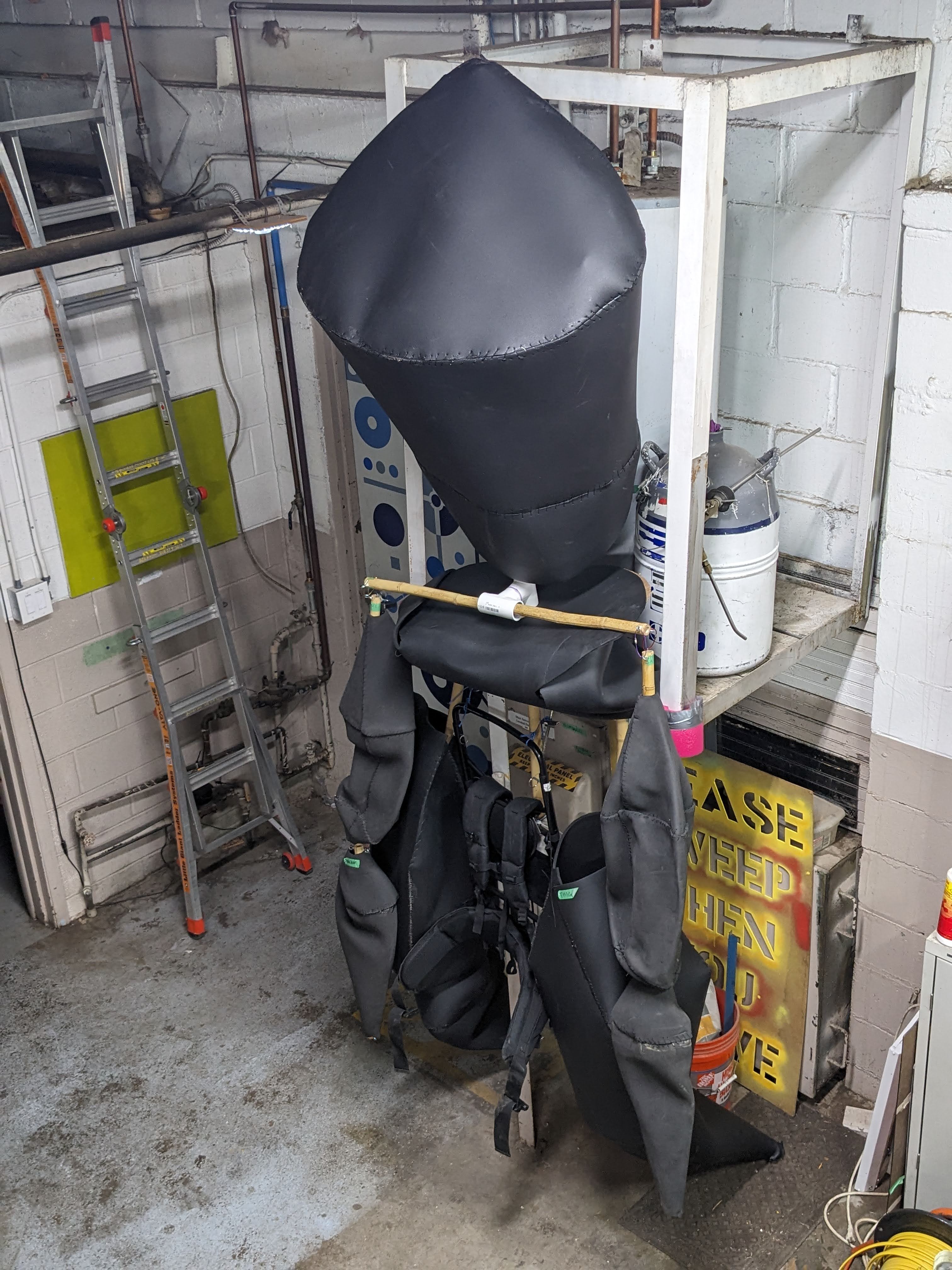 The shoulders are visible at the level of the pelvis. They are slotted over the spine but not yet lifted to shoulder-level and fastened in place.