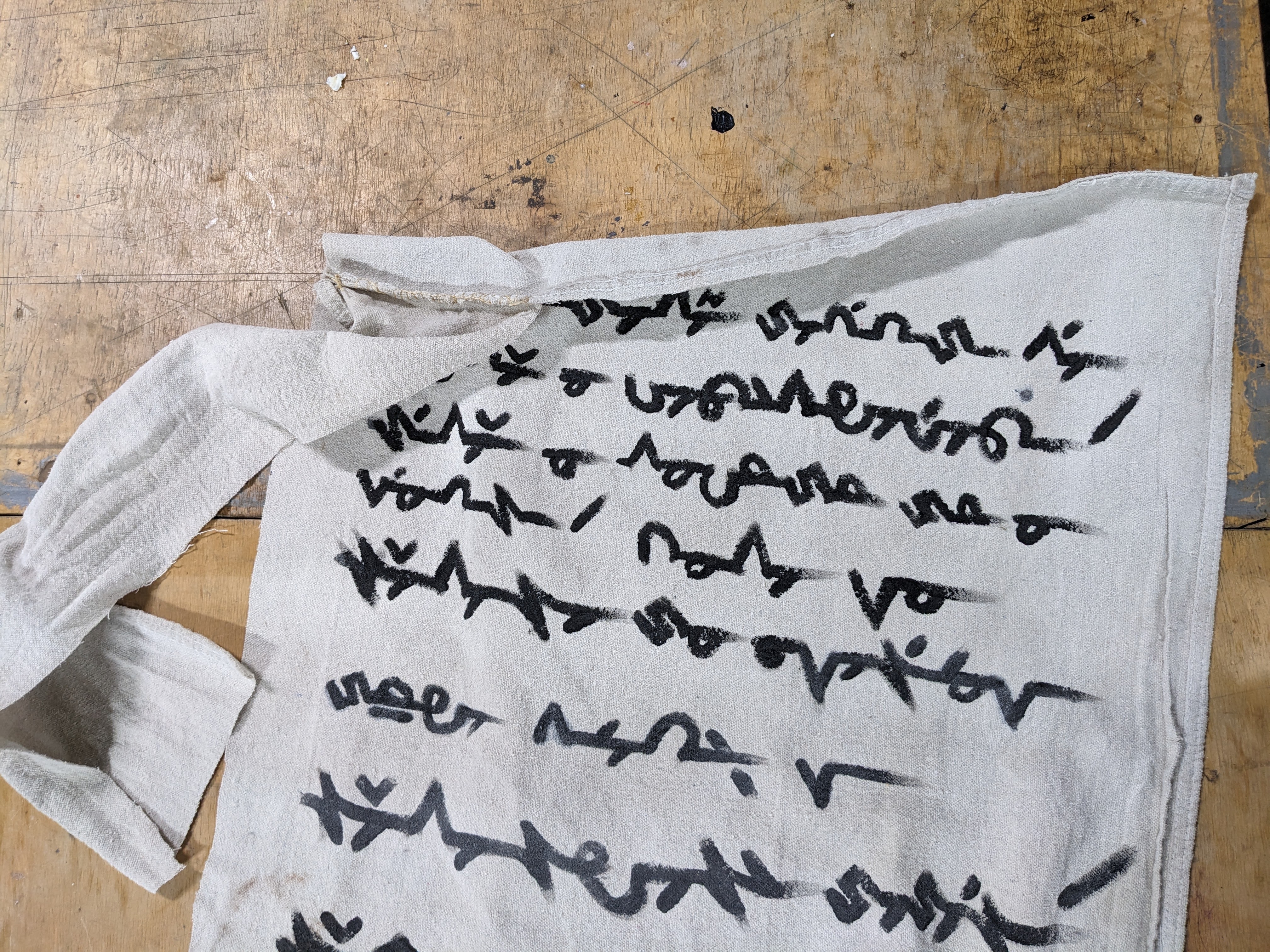 The Japanese script is changed to an invented alphabet which <a href="https://www.omniglot.com/conscripts/kakemoji.htm">someone on a conlang website</a> invented to write Japanese as beautifully as possible.